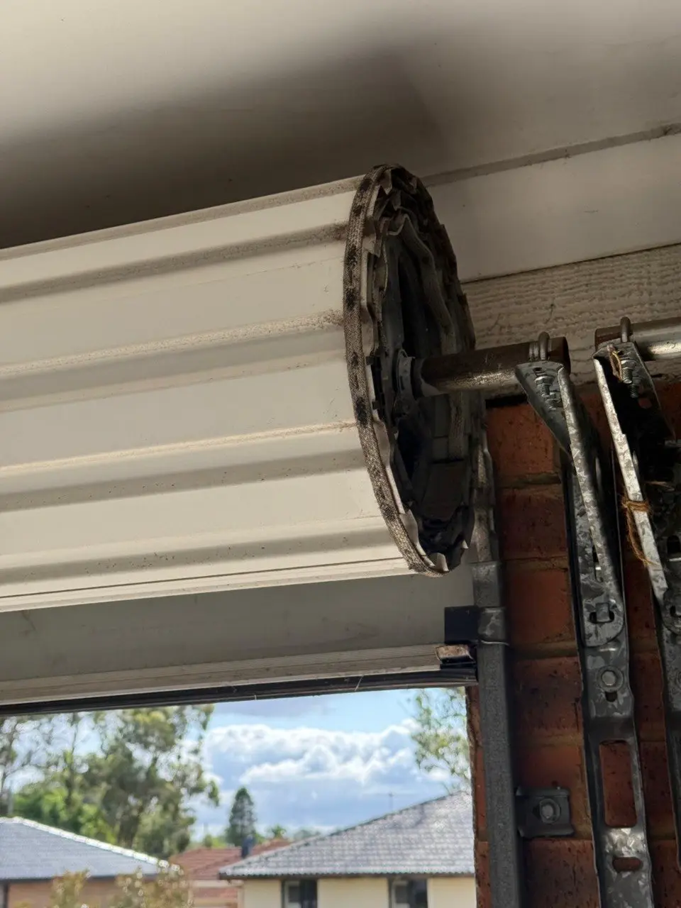Roller door drum axle and spring inspection